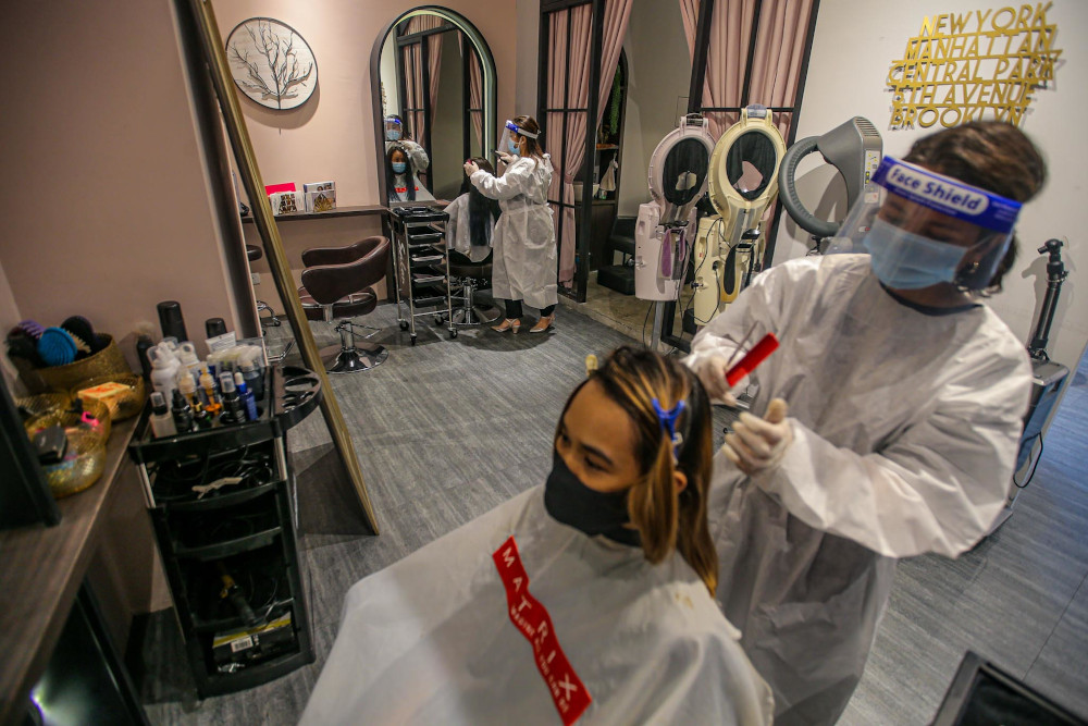 Hairkunst Hijabis salon workers perform a demonstration on other workers posing as customers at the hair salon in Melawati Mall on June 7, 2020. u00e2u20acu201d Picture by Hari Anggara