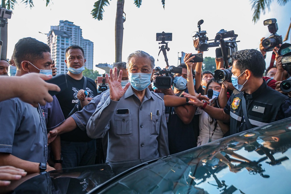 Tun Dr Mahathir Mohamad waves at reporters as he leaves PKR's headquarters following a four-hour meeting with other Pakatan leaders, in Petaling Jaya June 9, 2020. u00e2u20acu201d Picture by Hari Anggara