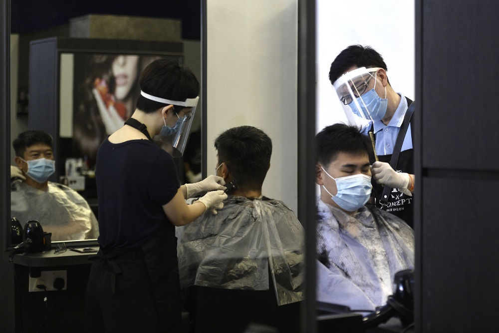 A customer gets his hair cut at the K Concept hair salon in Publika, Kuala Lumpur June 10, 2020. u00e2u20acu201d Picture by Miera Zulyana
