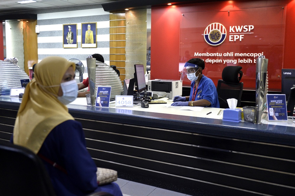 Staff wear protective gear as they work at the Employees Provident Fundu00e2u20acu2122s headquarters in Kuala Lumpur June 12, 2020. u00e2u20acu201d Picture by Miera Zulyana