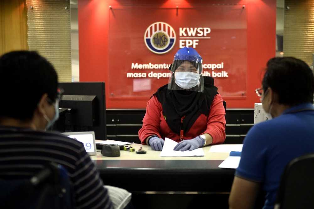 A staff member wears protective gear as she works at the Employees Provident Fundu00e2u20acu2122s headquarters in Kuala Lumpur June 12, 2020. u00e2u20acu201d Picture by Miera Zulyana