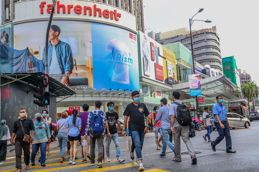 People are seen wearing protective masks as they walk along the Bukit Bintang shopping area in Kuala Lumpur May 31, 2020. u00e2u20acu2022 Picture by Firdaus Latif