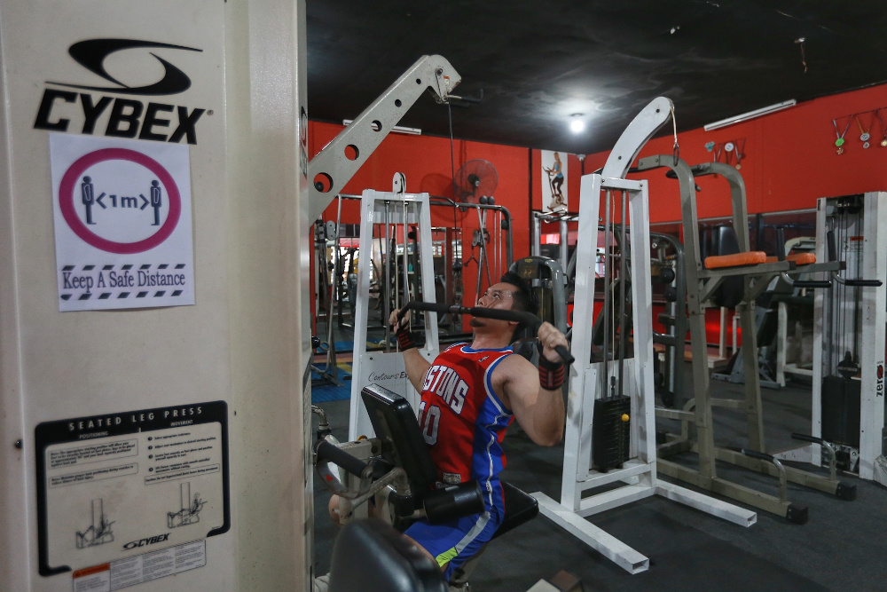 Gym goers start their workouts on the first day of gym reopening while practicing social distance and SOPs at Hyper Gym & Fitness Centre, Kota Damansara, June 15, 2020. u00e2u20acu201d Picture by Ahmad Zamzahuri