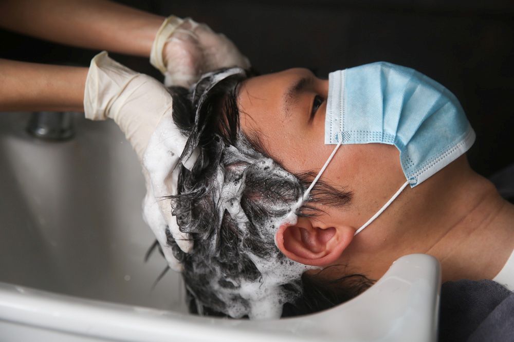 A regular customer has his hair washed at the Eighty Ninth Hair Studio June 10, 2020. u00e2u20acu201d Picture by Choo Choy May