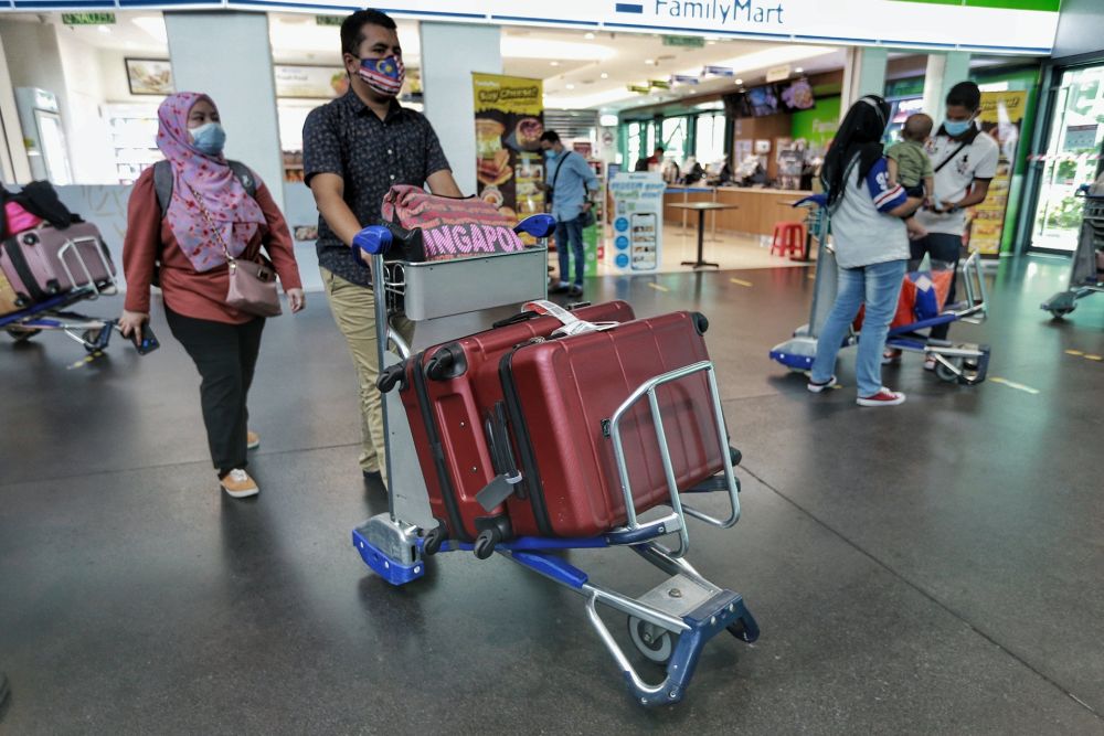 People wearing face masks are pictured at KLIA2, Sepang on the first day of the relaxed movement control order June 10, 2020. u00e2u20acu201d Picture by Ahmad Zamzahuri
