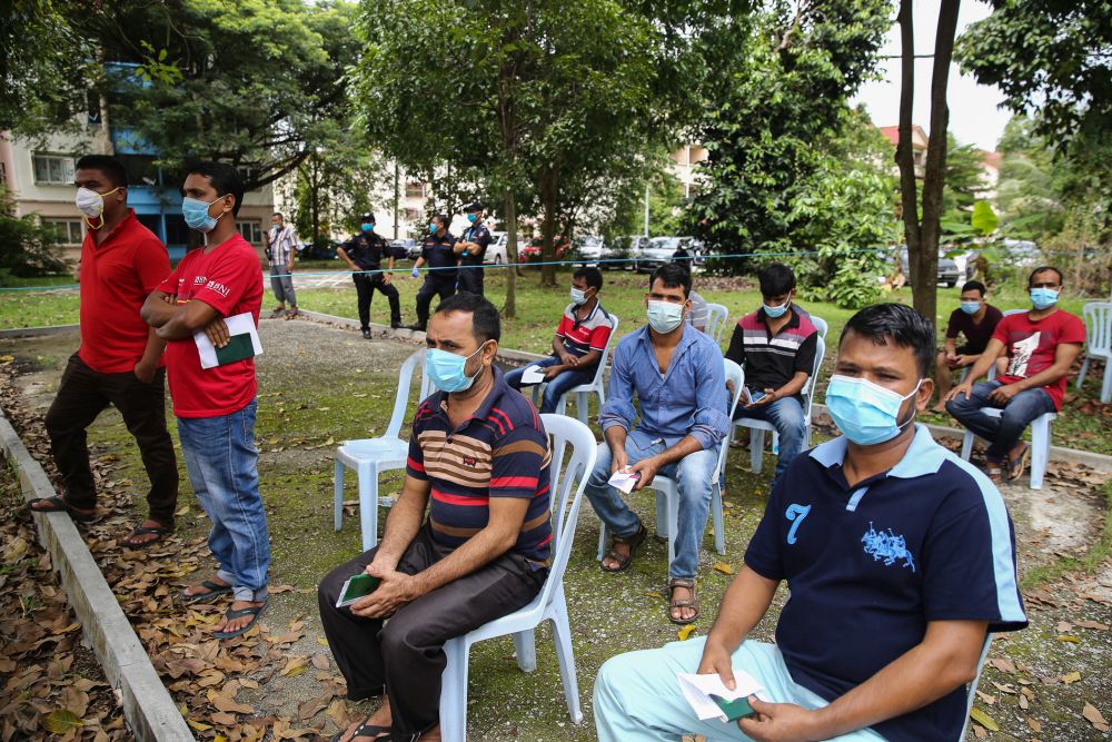 Foreign workers wait to be screened for Covid-19 in Taman Langat Murni, Kuala Langat June 4, 2020. u00e2u20acu201d Picture by Yusof Mat Isann