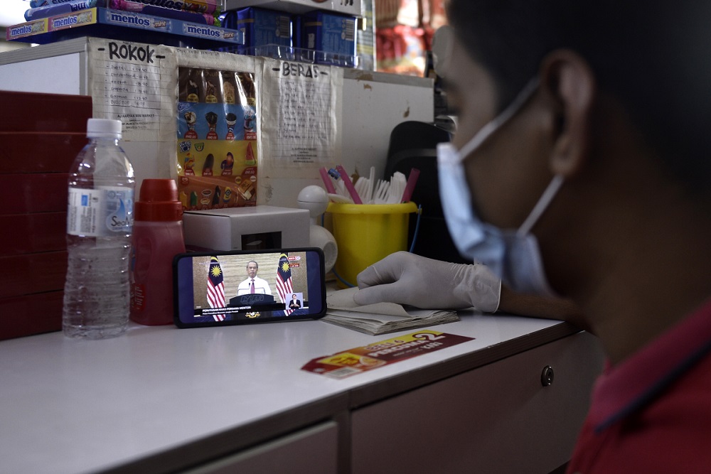 People watch the live telecast of Prime Minister Tan Sri Muhyiddin Yassin giving his speech, June 5, 2020. u00e2u20acu2022 Picture by Miera Zulyana