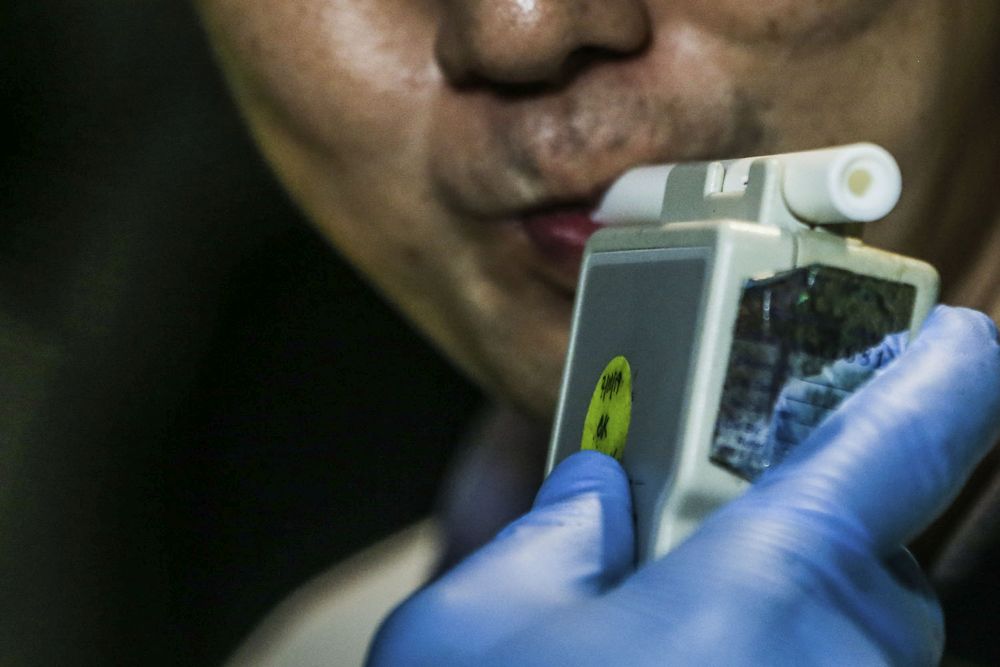 A man takes a breathalyser test at a police roadblock on Jalan Hang Tuah in Kuala Lumpur June 3, 2020. u00e2u20acu201d Picture by Hari Anggara 