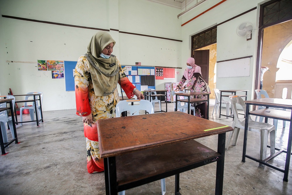 Teachers at the Sekolah Menengah Kebangsaan Main Convent in Ipoh preparing their classrooms to comply with the SOPs set by the government, June 23, 2020. Farhan Najib