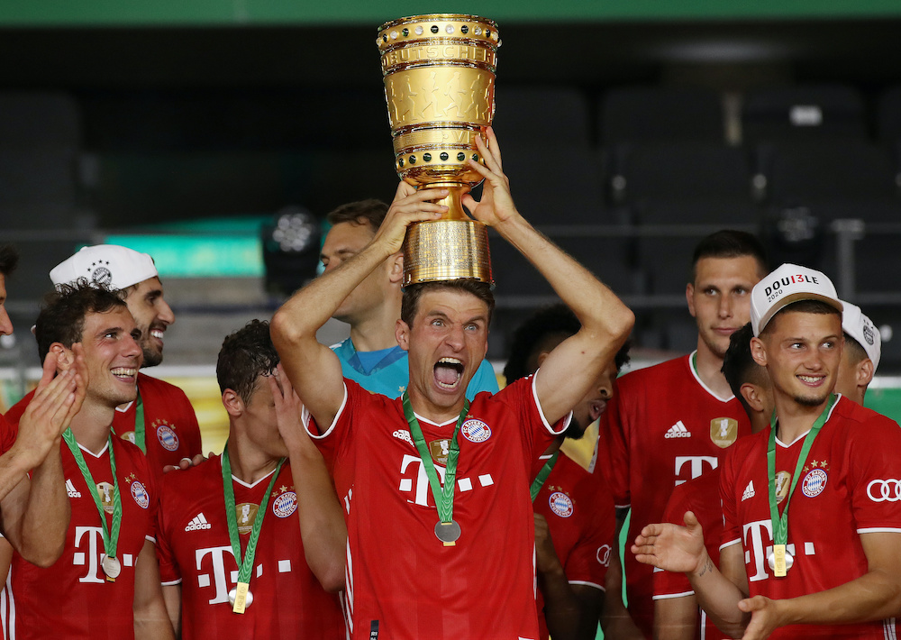 Bayern Munich's Thomas Mueller and teammates celebrate with the trophy after the match, July 4, 2020. u00e2u20acu201d Alexander Hassenstein/Pool via Reuters