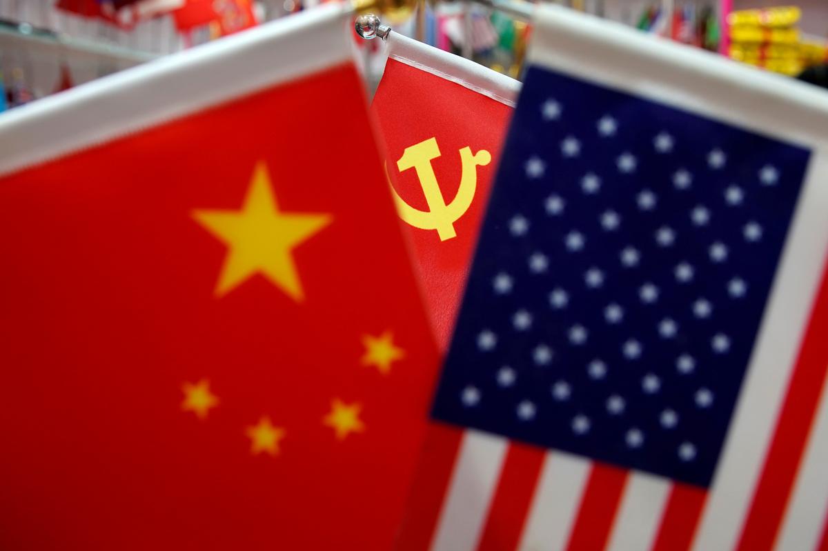 FILE PHOTO: The flags of China, U.S. and the Chinese Communist Party are displayed in a flag stall at the Yiwu Wholesale Market in Yiwu, Zhejiang province, China, May 10, 2019. REUTERS/Aly Song/File Photo