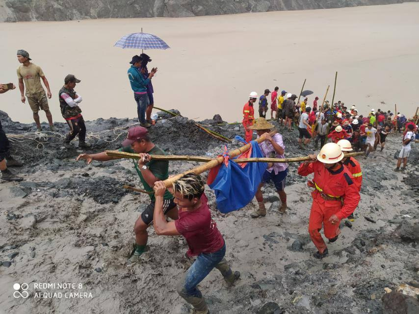 People carry a dead body following a landslide at a mining site in Phakant, Kachin State City, Myanmar July 2, 2020, in this picture obtained from social media. u00e2u20acu201d Myanmar Fire Services Department pic via Reuters
