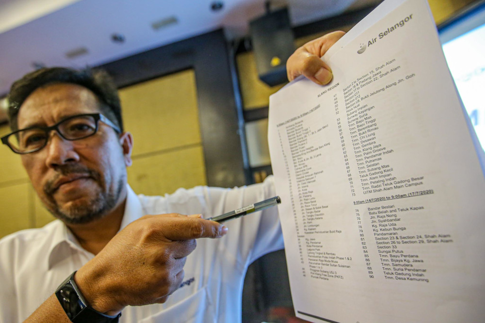 Pengurusan Air Selangor head of operations Abas Abdullah shows a list of affected areas at a press conference on the temporary shutdown for essential improvement works at Bukit Kiara Equestrian & Country Resort July 6, 2020. u00e2u20acu201d Picture by Hari Anggara