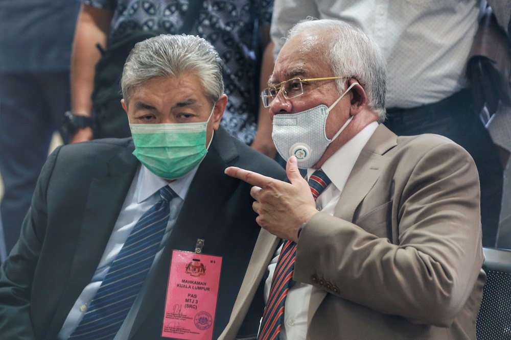 Datuk Seri Zahid Hamidi is seen chatting with Datuk Seri Najib Razak at the Kuala Lumpur court complex July 28,2020. u00e2u20acu201d Picture by Ahmad Zamzahuri