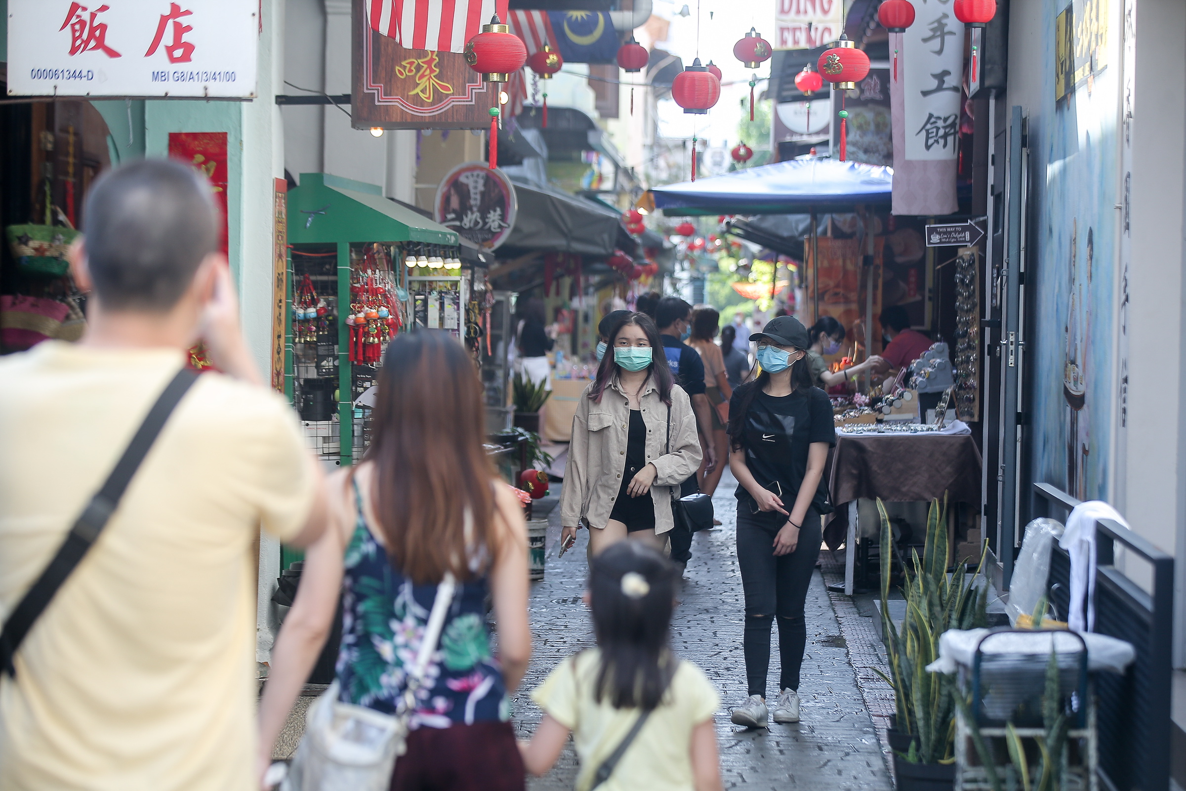 Domestic tourists visit Ipohu00e2u20acu2122s Concubine Lane.  After months of lockdown due to the Covid-19 pandemic, Ipoh Town is gradually returning to its lively bustling atmosphere as tourist spots attract domestic tourists. u00e2u20acu201d Picture by Farhan Najib