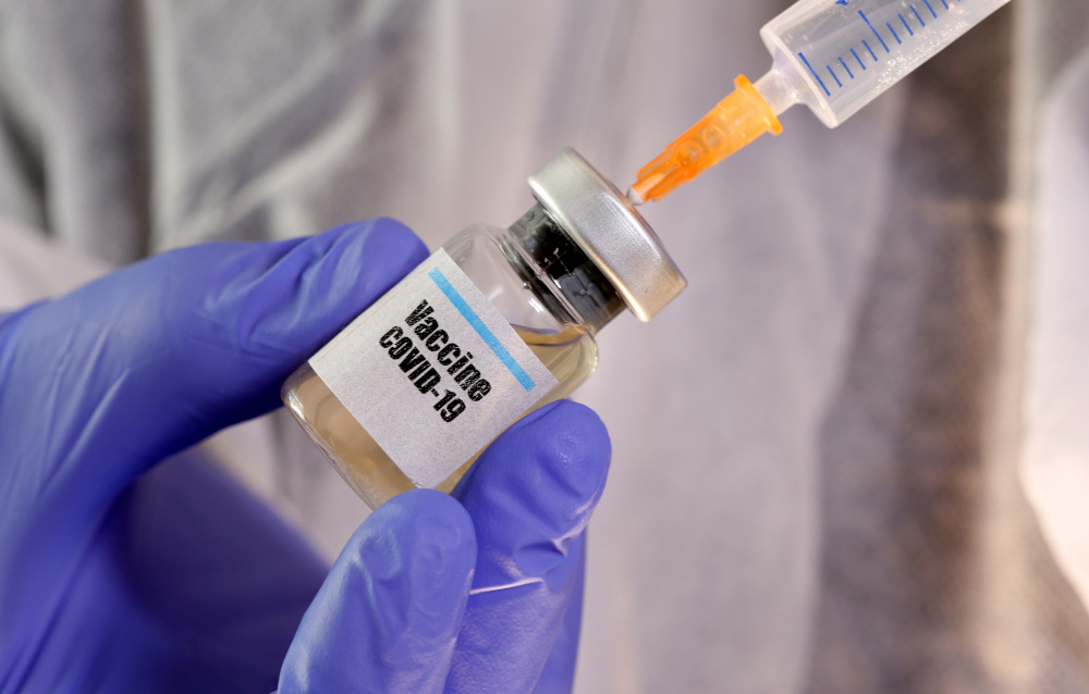 A woman holds a small bottle labelled with a u00e2u20acu02dcVaccine Covid-19u00e2u20acu2122 sticker and a medical syringe in this illustration taken April 10, 2020. u00e2u20acu201d Reuters pic 