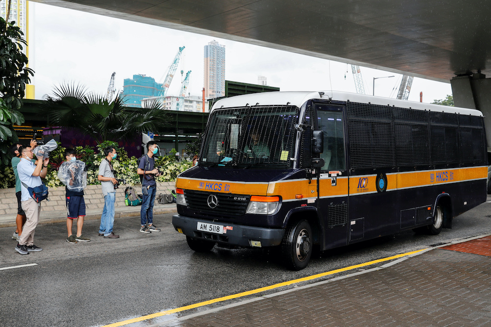 Journalists wait outside West Kowloon Magistratesu00e2u20acu2122 Courts, after a motorcyclist accused of riding into a group of policemen during the protest, while carrying a flag calling for the liberation of Hong Kong, has been charged under the newly passed nation