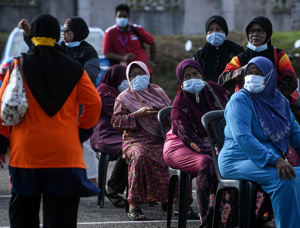 Voters wait for their turn to cast their votes at the Kelas Al-Quran dan Fardu Ain (KAFA) polling centre in Pekan July 4, 2020. u00e2u20acu2022 Bernama pic