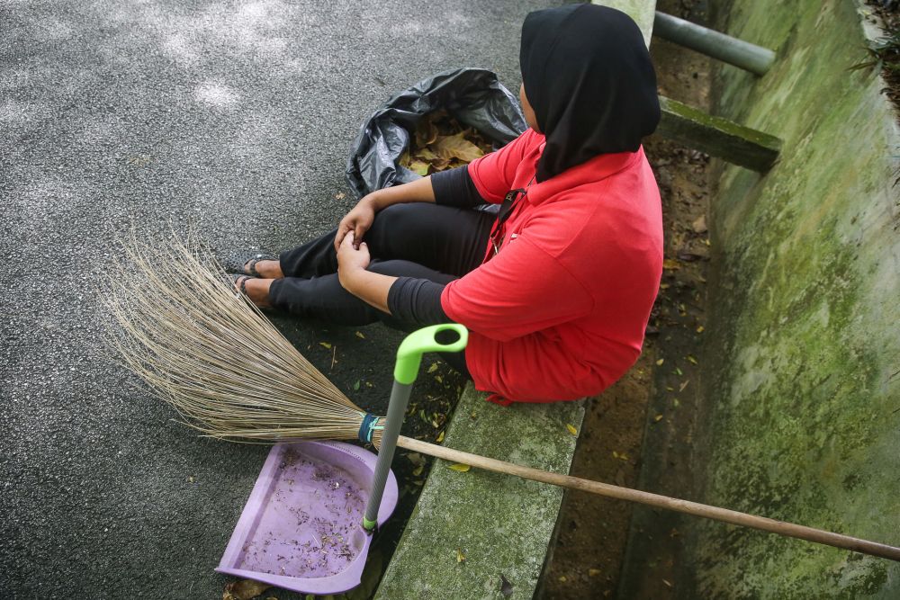 Apartment building cleaner Ahoi takes a breather from her duties in Damansara July 30, 2020. u00e2u20acu2022 Picture by Yusof Mat Isa