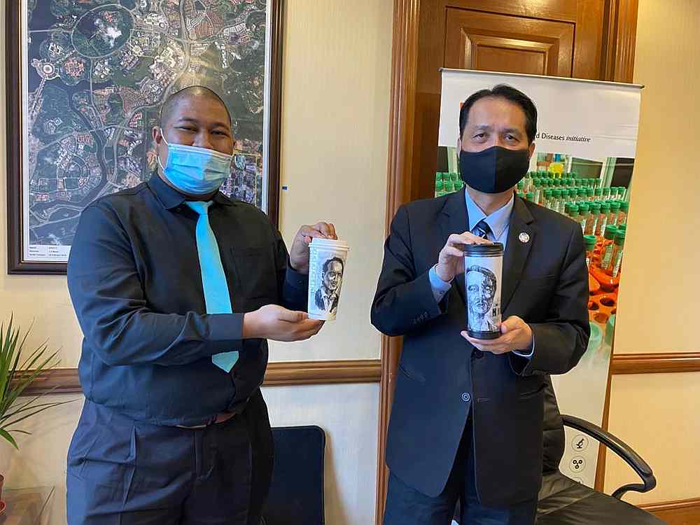 Artist Luqman Hakim meets Health director-general Datuk Dr Noor Hisham Abdullah at the Health Ministry in Putrajaya. u00e2u20acu201d Picture courtesy of Luqman Hakim