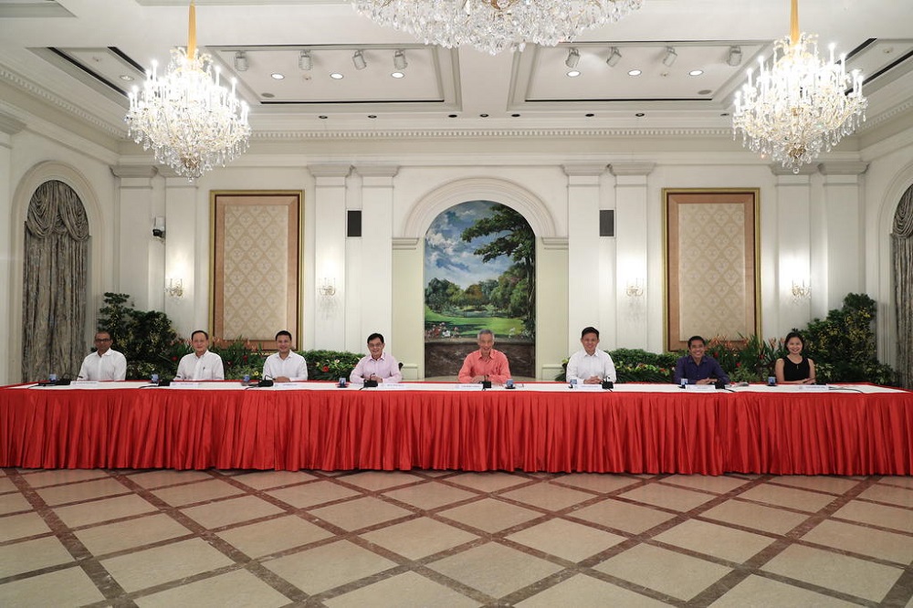 Singapore Prime Minister Lee Hsien Loong, flanked by seven political office holders, during a briefing today to unveil the latest Cabinet line-up. u00e2u20acu201d Picture by Singapore Ministry of Communication and Information via TODAY