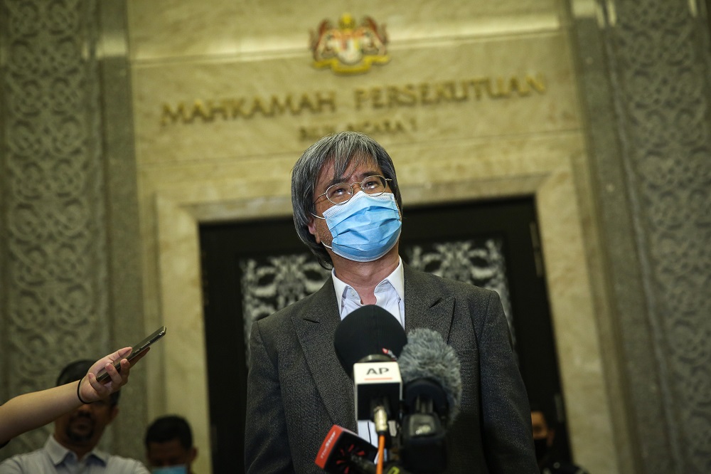 Malaysiakini editor-in-chief Steven Gan speaks to reporters outside the courtroom at the Federal Court in Putrajaya July 2, 2020. u00e2u20acu2022 Picture by Yusof Mat Isa