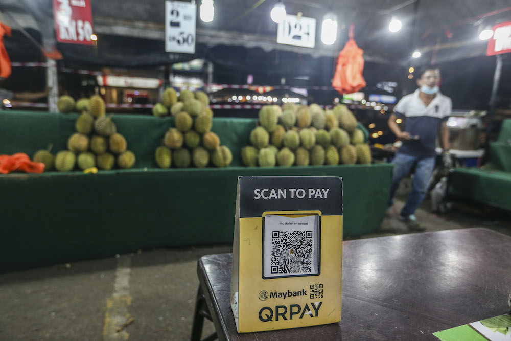 A vendor displays an e-wallet acceptance board at his durian stall in Setapak August 15, 2020. u00e2u20acu201d Picture by Firdaus Latif 