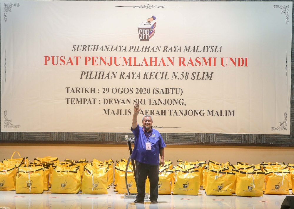 BN candidate Mohd Zaidi Aziz, 43, celebrates at Dewan Sri Tanjung in Tanjung Malim after winning the state seat in the Slim by-election August 29, 2020. u00e2u20acu201d Picture by Farhan Najib