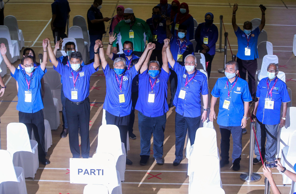 BN candidate Mohd Zaidi Aziz (centre) celebrates with coalition leaders and supporters at Dewan Sri Tanjung in Tanjung Malim after retaining the state seat in the Slim by-election August 29, 2020. u00e2u20acu201d Picture by Farhan Najib