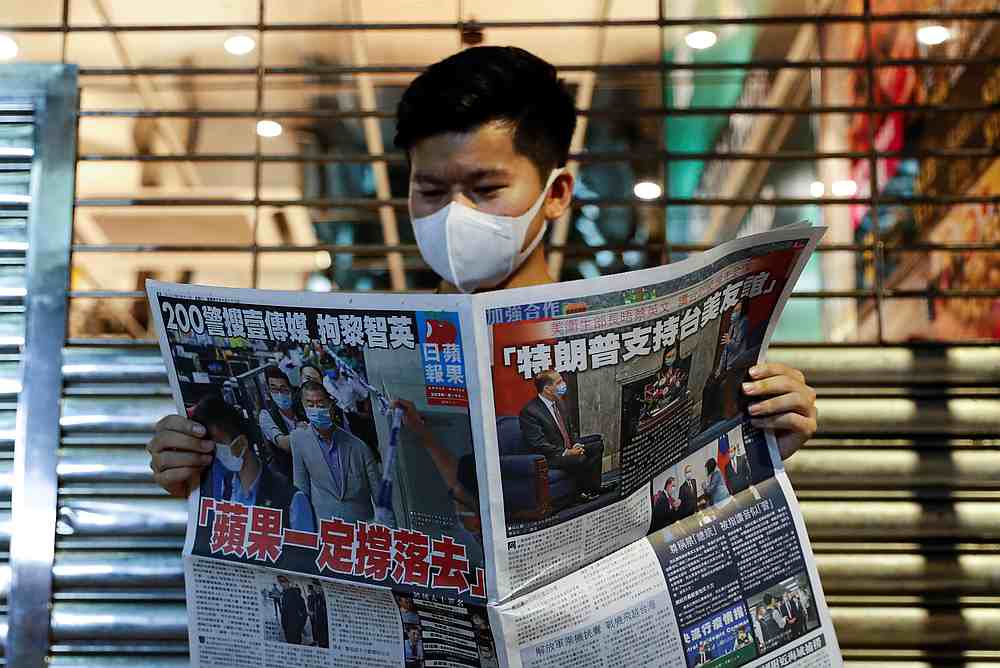 A supporter of Apple Daily newspaper, reads a copy of the newspaper to support media mogul Jimmy Lai Chee-ying, founder of Apple Daily after he was arrested in Hong Kong August 11, 2020. u00e2u20acu201d Reuters pic
