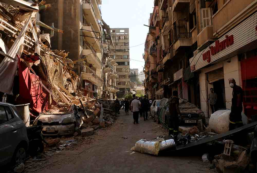 People walk past damaged buildings and vehicles following the blast in Beirut's port area, Lebanon August 5, 2020. u00e2u20acu201d Reuters pic