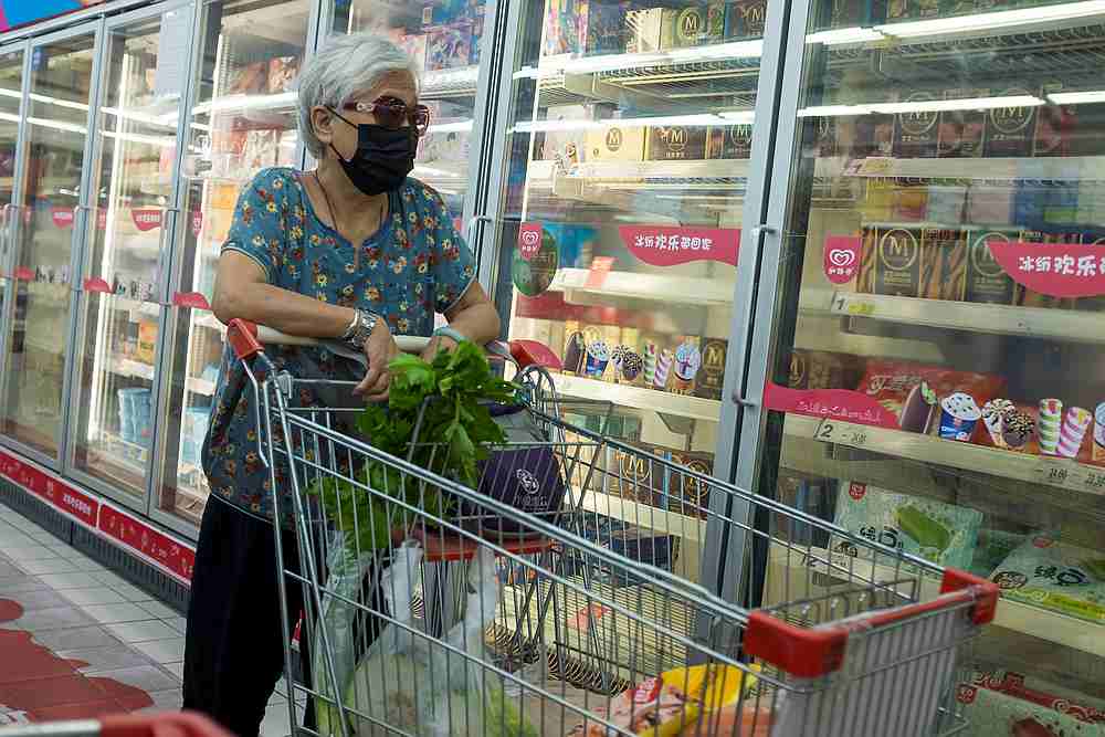 A woman looks at frozen food products in a supermarket following an outbreak of Covid-19 in Beijing, China August 13, 2020. u00e2u20acu201d Reuters pic