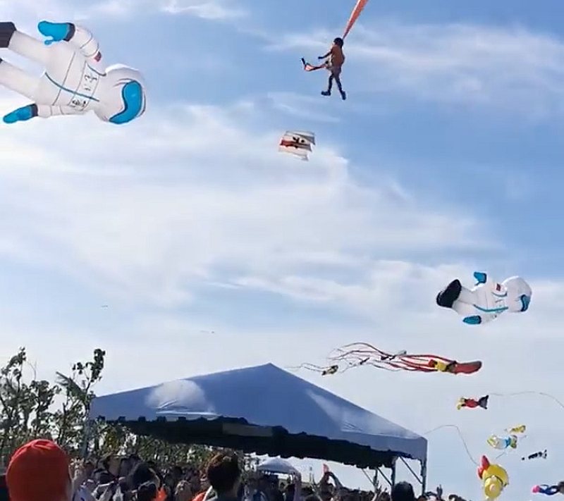 A child is pulled up in the air by a kite at an International Kite Flying Festival, in Hsinchu, Taiwan August 30, 2020. u00e2u20acu201d Screengrab from Facebook @viasblog.tw via Reuters