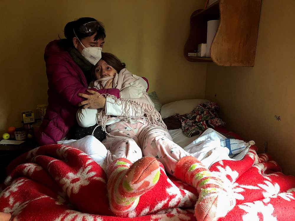 A woman, who is infected with Covid-19, reacts when she is told about the death of her father Jose, 92, due to complications related to Covid-19 in Santiago, Chile July 1, 2020. u00e2u20acu201d Reuters pic