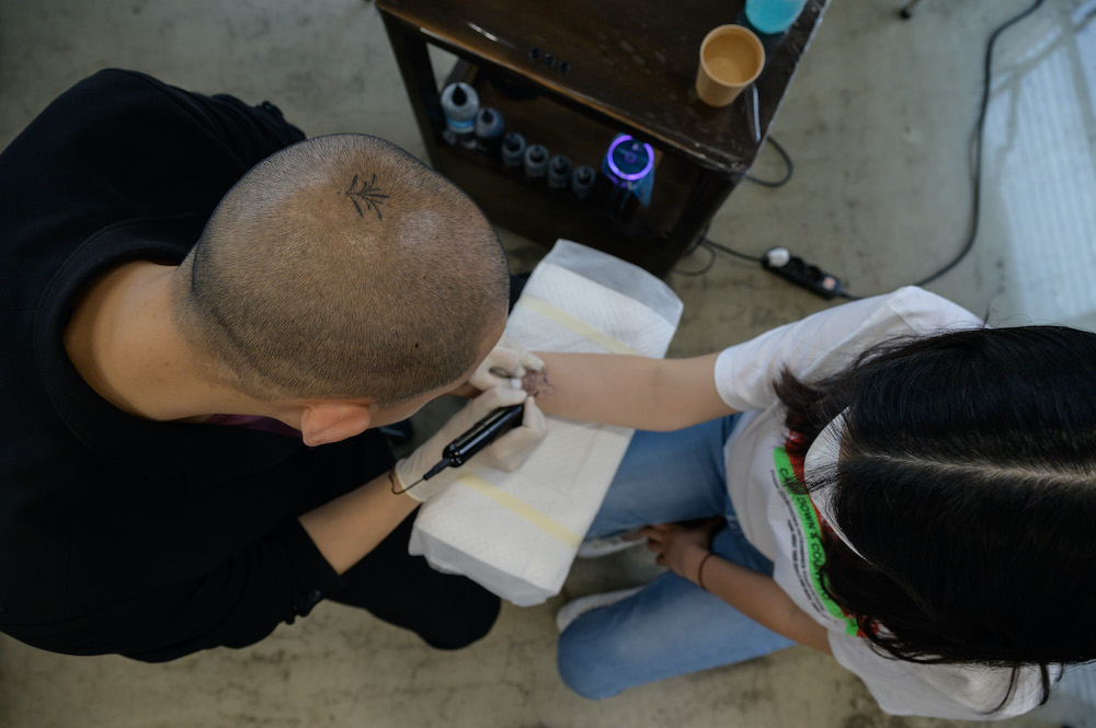 In a photo taken on July 8, 2020 tattoo artist Doy works on a client at his studio in Seoul. u00e2u20acu201d AFP pic