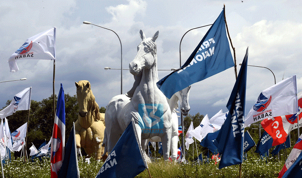 Parties contesting in the state election put up their flags at the Bulatan Kuda Jalan Tuaran. u00e2u20acu201d Bernama pic