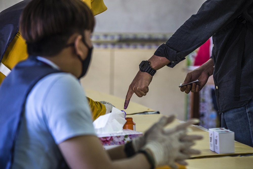 A voter gets his finger marked with indelible ink at the voting station located at SK Pulau Gaya September 26, 2020. u00e2u20acu201d Picture by Firdaus Latif