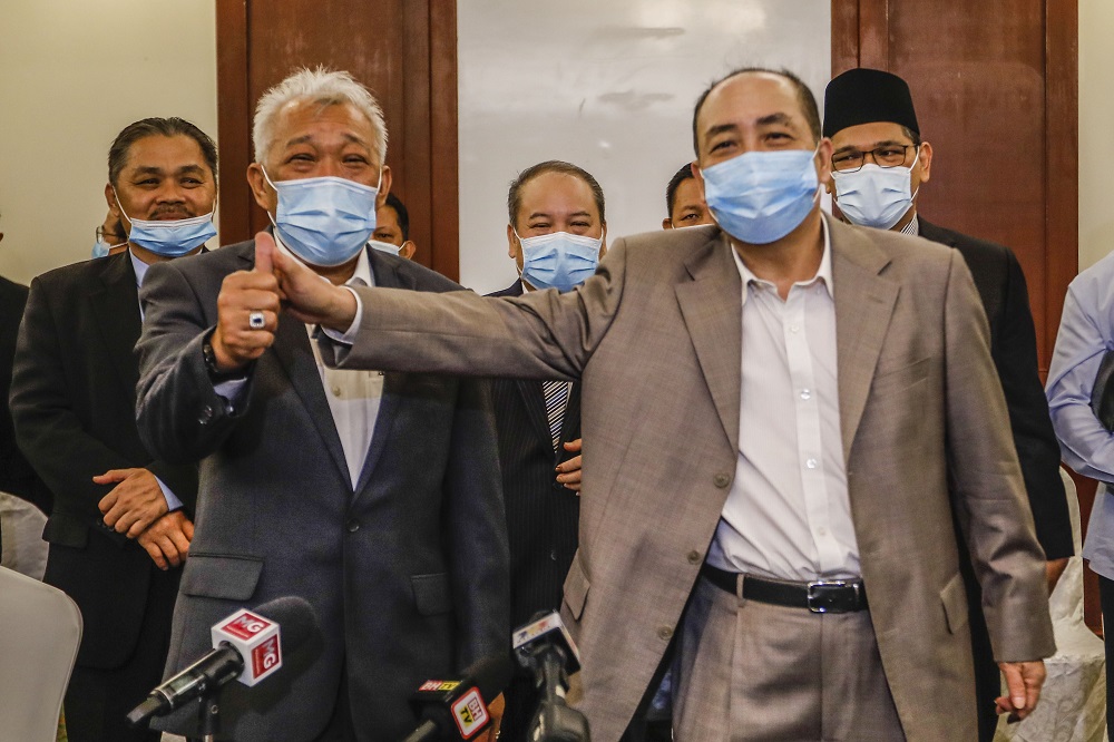 Sabah BN chairman and Umno chief Datuk Seri Bung Moktar Radin and Sabah Bersatu chief Datuk Hajiji Noor pose for a photo after the press conference at Hotel Magellan in Kota Kinabalu September 28, 2020. u00e2u20acu201d Picture by Firdaus Latif