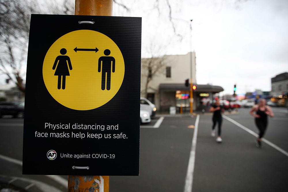 People jog past a social distancing sign as New Zealand's latest Covid-19 safety measure are implemented in Auckland, New Zealand August 31, 2020. u00e2u20acu201d Reuters pic