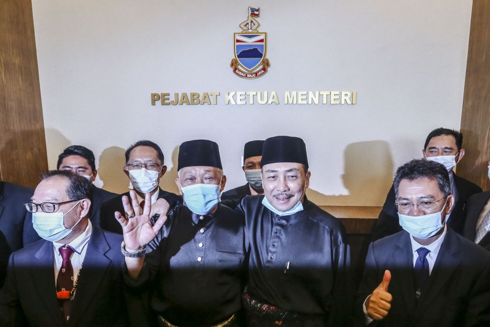 Sabah Chief Minister Datuk Hajiji Noor (second from right) and Datuk Seri Bung Moktar Radin (second from left) pose for a photo at the state administrative building in Kota Kinabalu September 29, 2020. u00e2u20acu201d Picture by Firdaus Latif