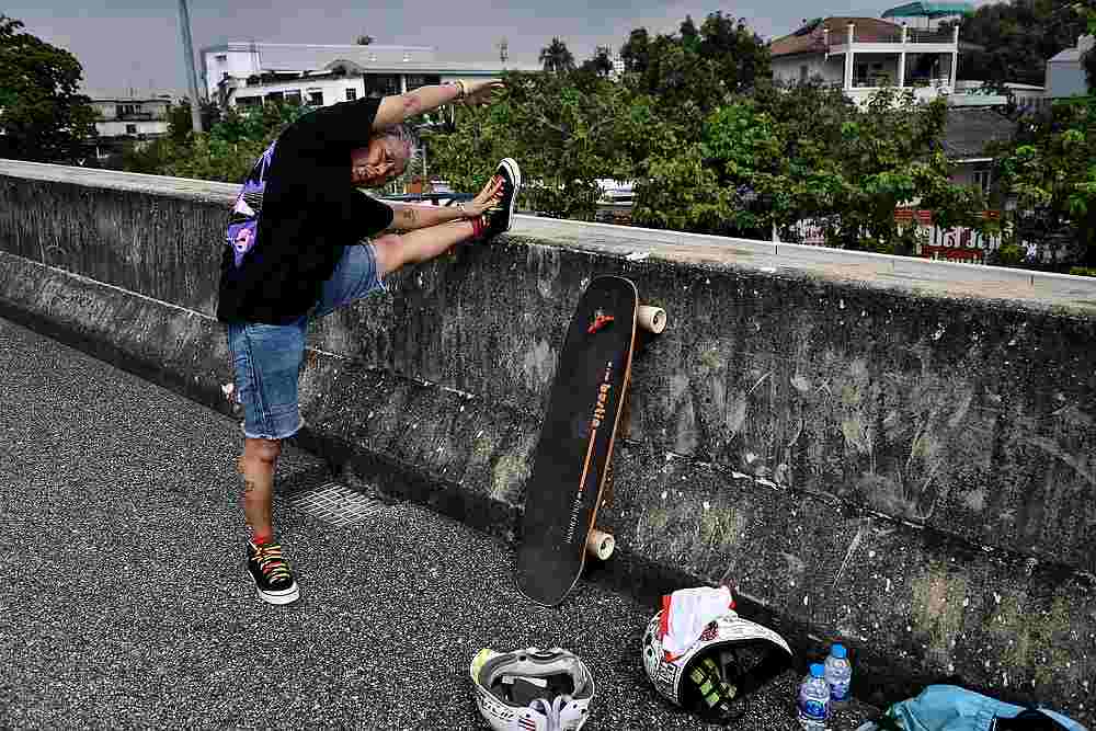 Longboarder and cancer survivor Nongluck Chairuettichai, also known as Jeab, stretching before a practice session in Bangkok September 9, 2020. u00e2u20acu201d AFP pic