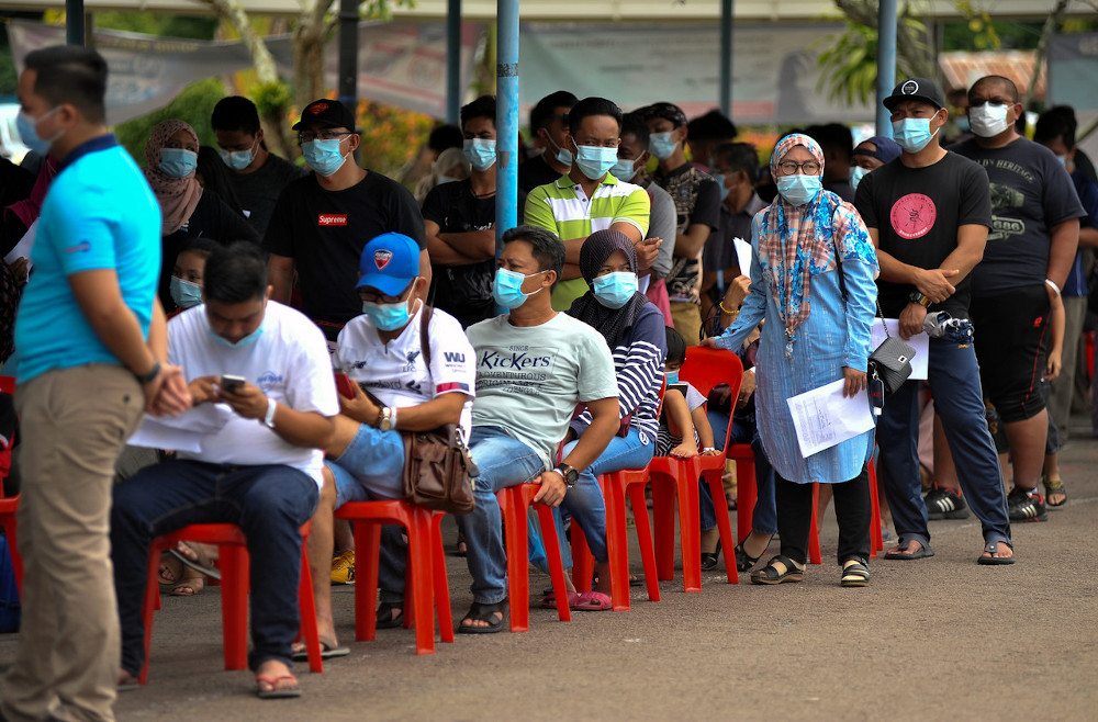 People returning from the mainland wait for their turns for the Covid-19 and Polymerase Chain Reaction (PCR) tests at the Membedai Health Clinic in Labuan, September 29, 2020. u00e2u20acu201d Bernama pic