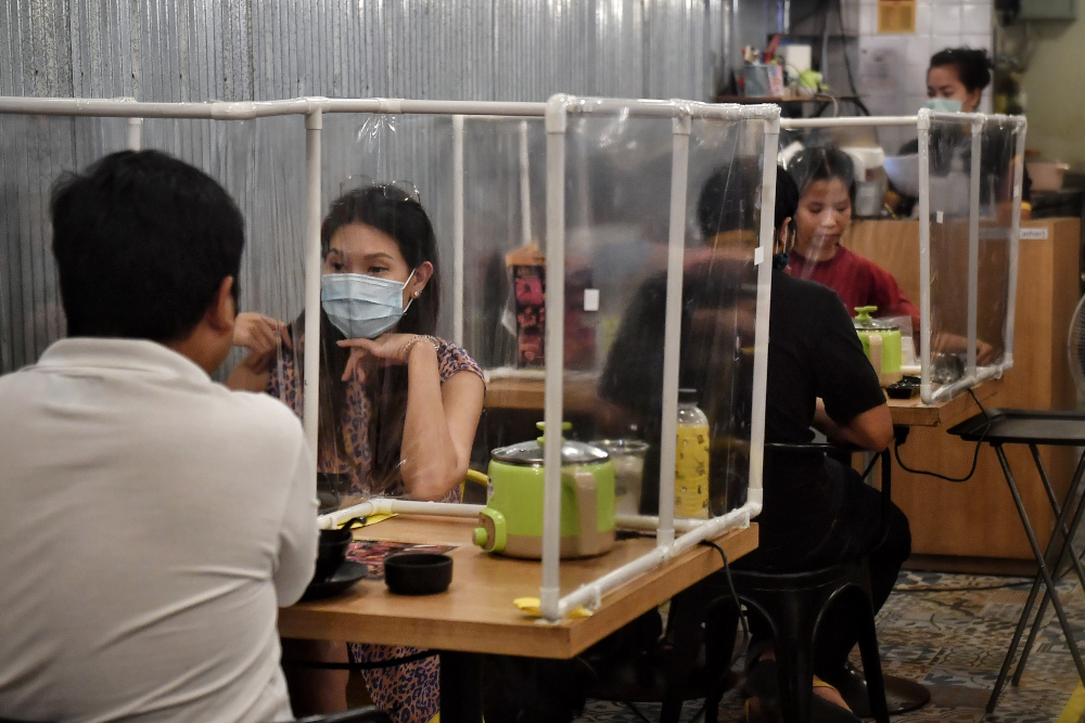 Customers sit in between plastic partitions, set up in an effort to contain any spread of the Covid-19 coronavirus, as they eat at the Penguin Eat Shabu hotpot restaurant in Bangkok, May 5, 2020. u00e2u20acu201d AFP pic 