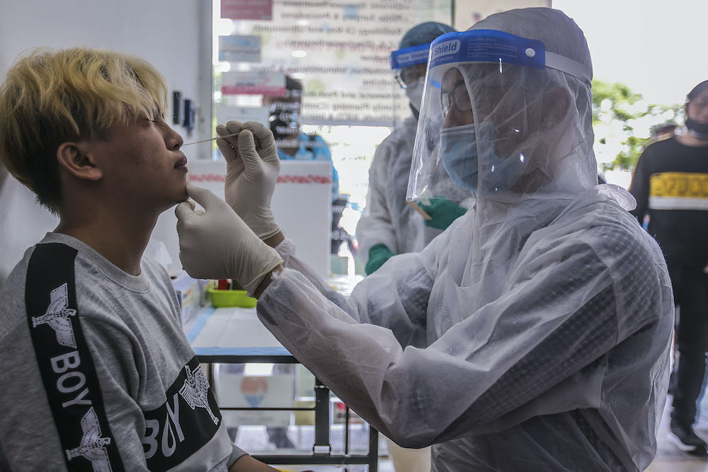 Healthcare workers carry out Covid-19 screening for those with a recent travel history to Sabah at Selcare Clinic in Shah Alam October 4, 2020. u00e2u20acu201d Picture by Hari Anggara