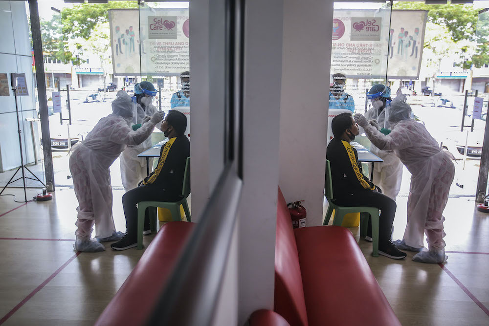 Healthcare workers carry out Covid-19 screening for those with a recent travel history to Sabah at Selcare Clinic in Shah Alam October 4, 2020. u00e2u20acu201d Picture by Hari Anggara