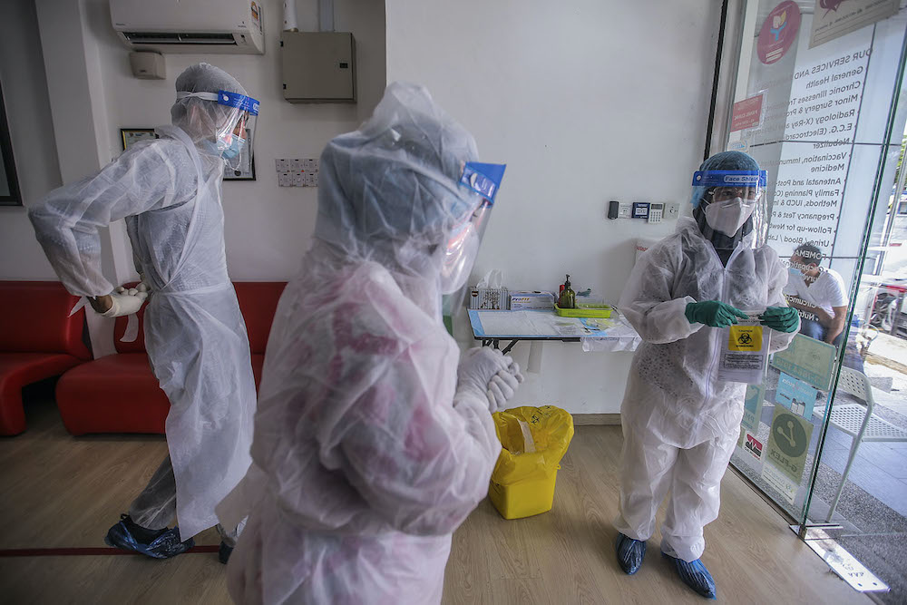 Healthcare workers prepare to carry out Covid-19 screening for those with a recent travel history to Sabah at Selcare Clinic in Shah Alam October 4, 2020. u00e2u20acu201d Picture by Hari Anggara