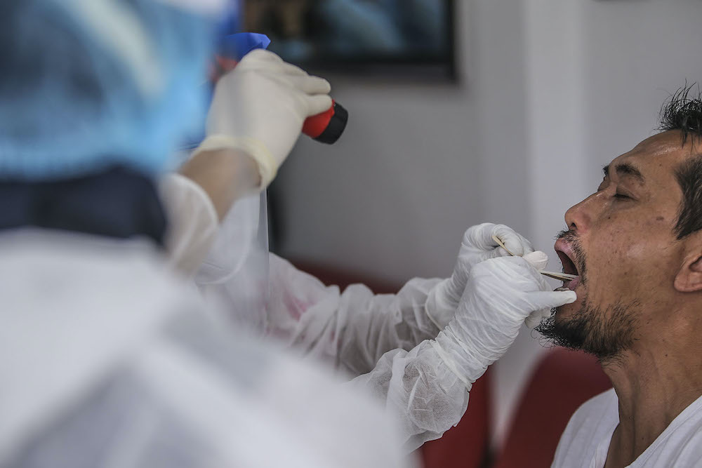 Healthcare workers carry out Covid-19 screening for those with a recent travel history to Sabah at Selcare Clinic in Shah Alam October 4, 2020. u00e2u20acu201d Picture by Hari Anggara