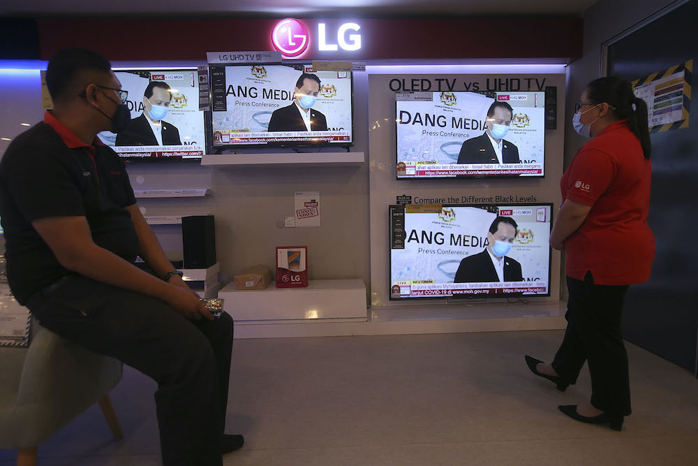 Television screens show Director General of Health Malaysia Tan Sri Dr Noor Hisham Abdullah holding a press conference from his home during his quarantine, October 6, 2020. u00e2u20acu201d Picture by Hari Anggara