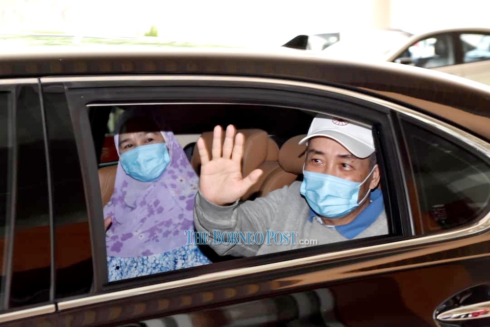 Hajiji and Julia wave to the medical personnel as they leave QEH today. u00e2u20acu201d Borneo Post Online pic