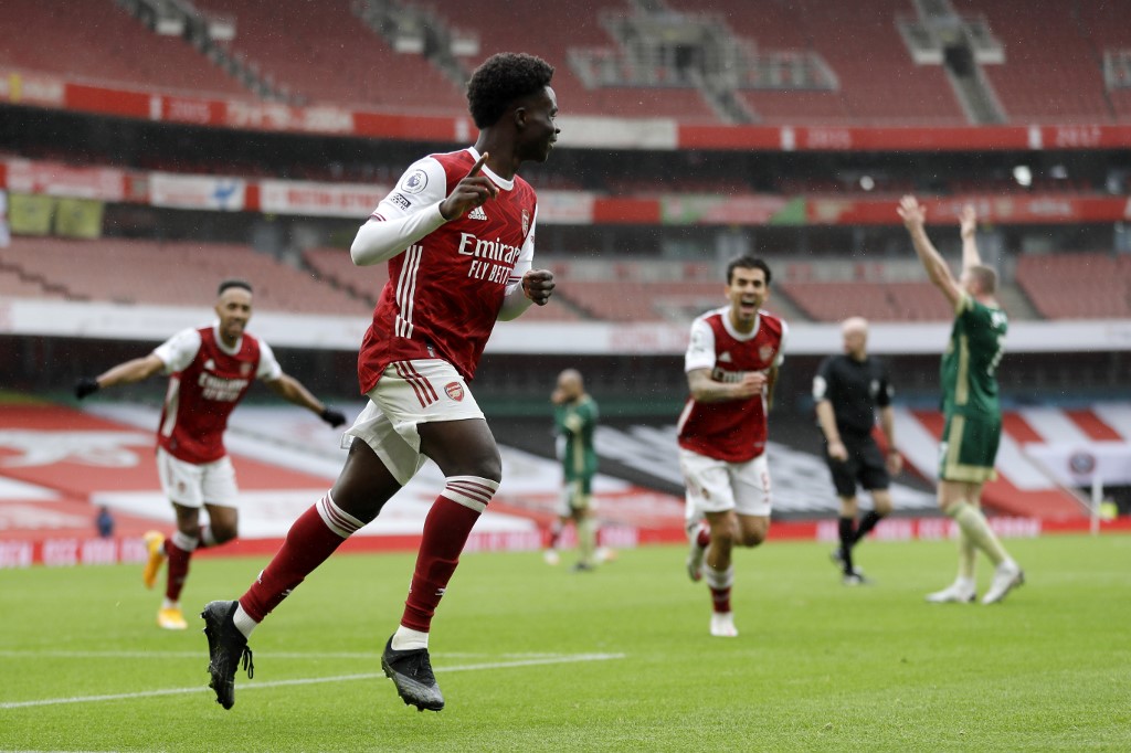 Arsenal's English striker Bukayo Saka (centre) celebrates scoring the opening goal during the English Premier League football match between Arsenal and Sheffield United at the Emirates Stadium in London on October 4, 2020. u00e2u20acu201d AFP pic